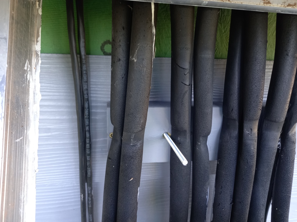 I forgot to take a picture from further back, but these are the linesets coming from the attic. Just a bunch of black electric and refrigerant lines cascading down the side of the house. Looks terrible. 
